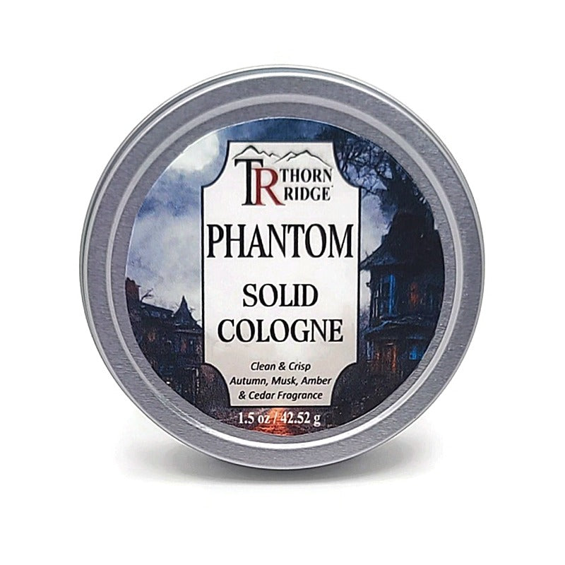 A silver tin of Thorn Ridge solid cologne labeled "Phantom," described as a clean and crisp autumn, musk, amber, and cedar  fragrance. 1.5 oz.