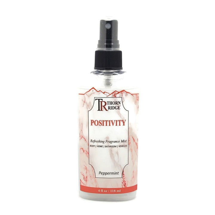 A bottle of Thorn Ridge fragrance mist labeled "Positivity," described as a peppermint scent for body, home, bathroom, and vehicles. 4 fl oz.