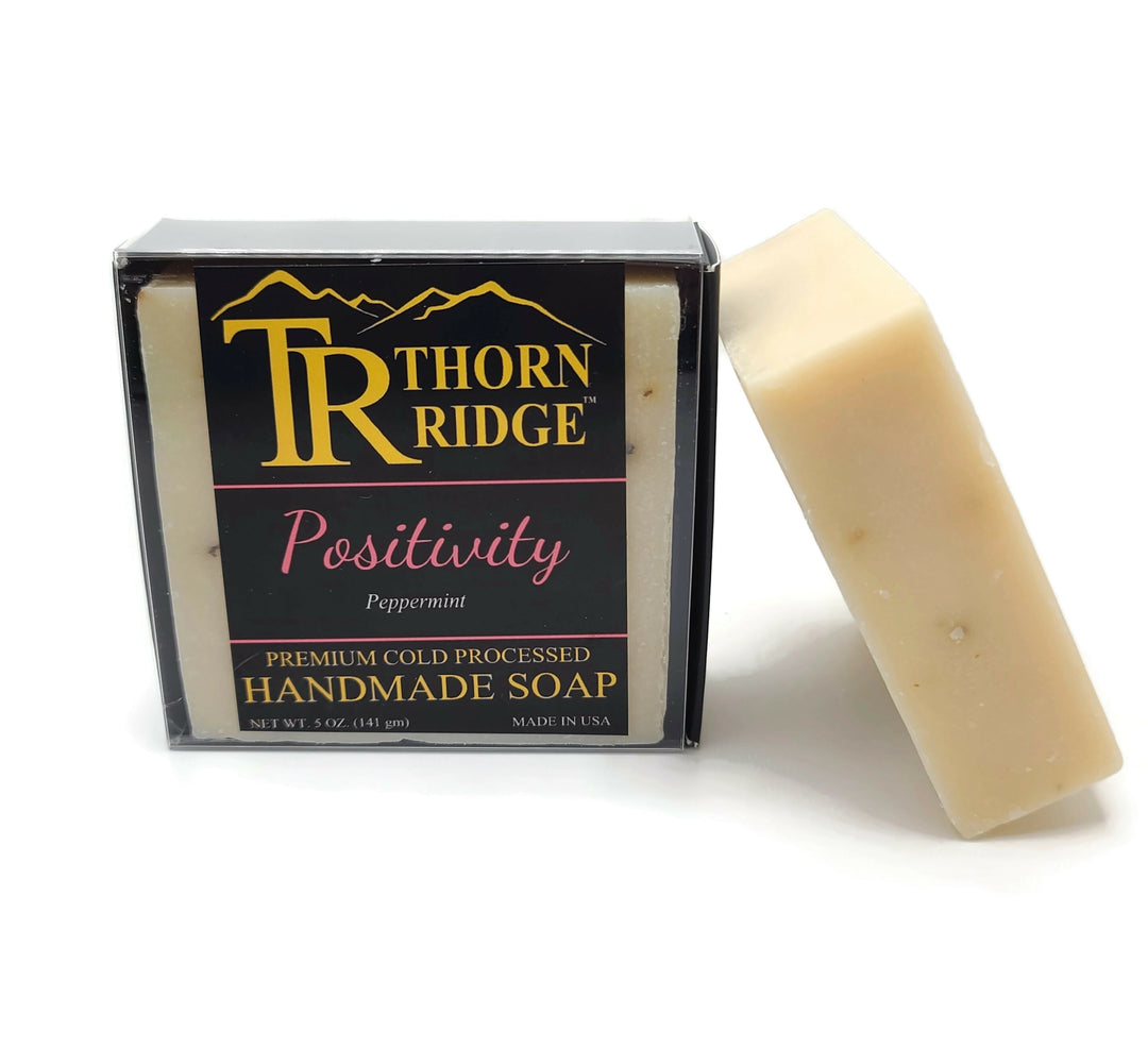 Packaging of Thorn Ridge soap labeled "Positivity," described as peppermint, premium cold processed, handmade, 5 oz. Made in USA.