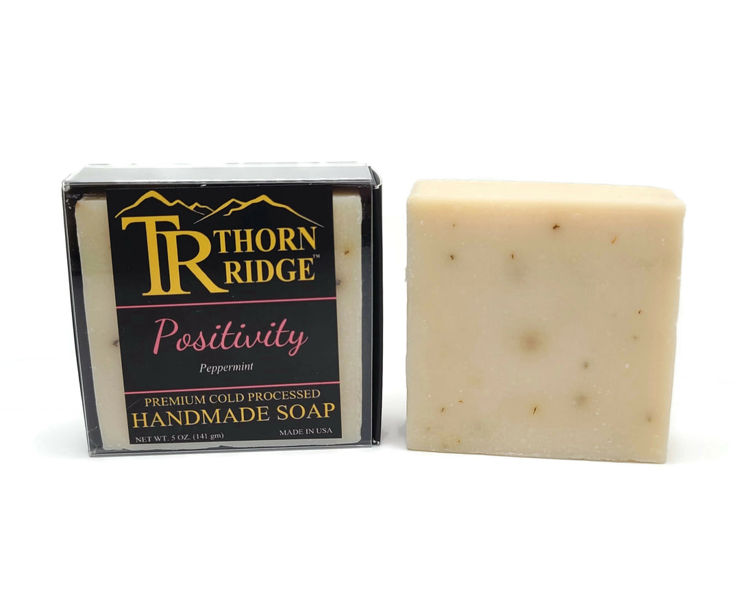 Packaging of Thorn Ridge soap labeled "Positivity," described as peppermint, premium cold processed, handmade, 5 oz. Made in USA.