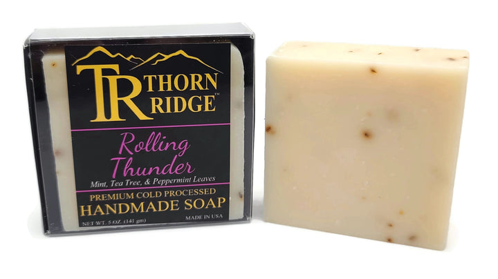 Packaging of Thorn Ridge soap labeled "Rolling Thunder," described as mint, tea tree, and peppermint leaves, premium cold processed, handmade, 5 oz. Made in USA.