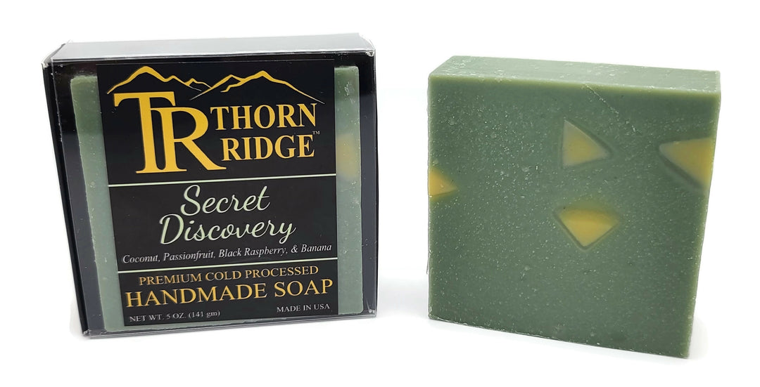 Packaging of Thorn Ridge soap labeled "Secret Discovery," described as coconut, passionfruit, black raspberry, banana, premium cold processed, handmade, 5 oz. Made in USA.