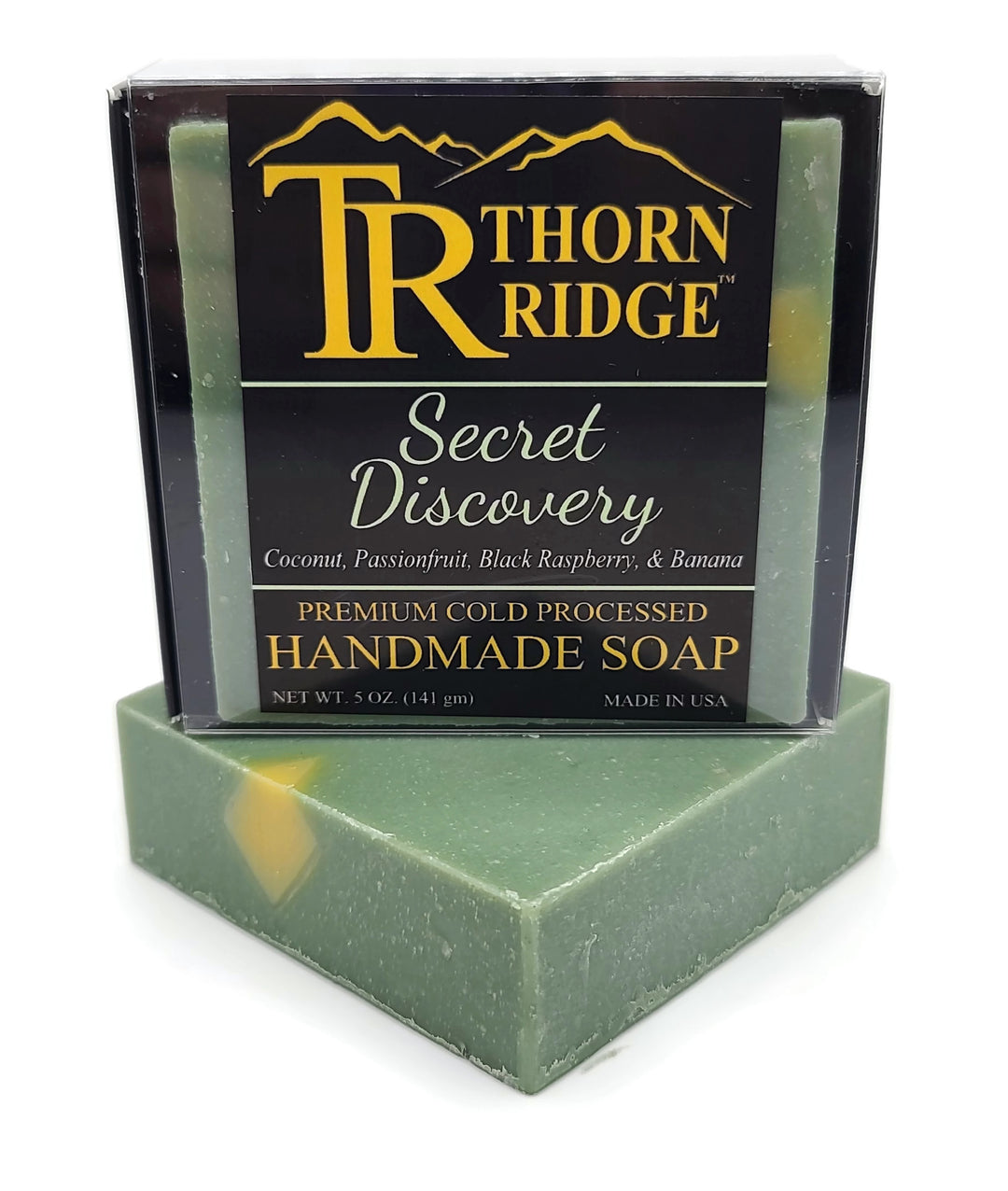 Packaging of Thorn Ridge soap labeled "Secret Discovery," described as coconut, passionfruit, black raspberry, banana, premium cold processed, handmade, 5 oz. Made in USA.