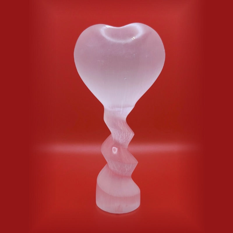 Thorn Ridge Selenite Heart Shaped Wand Figurine on red background.