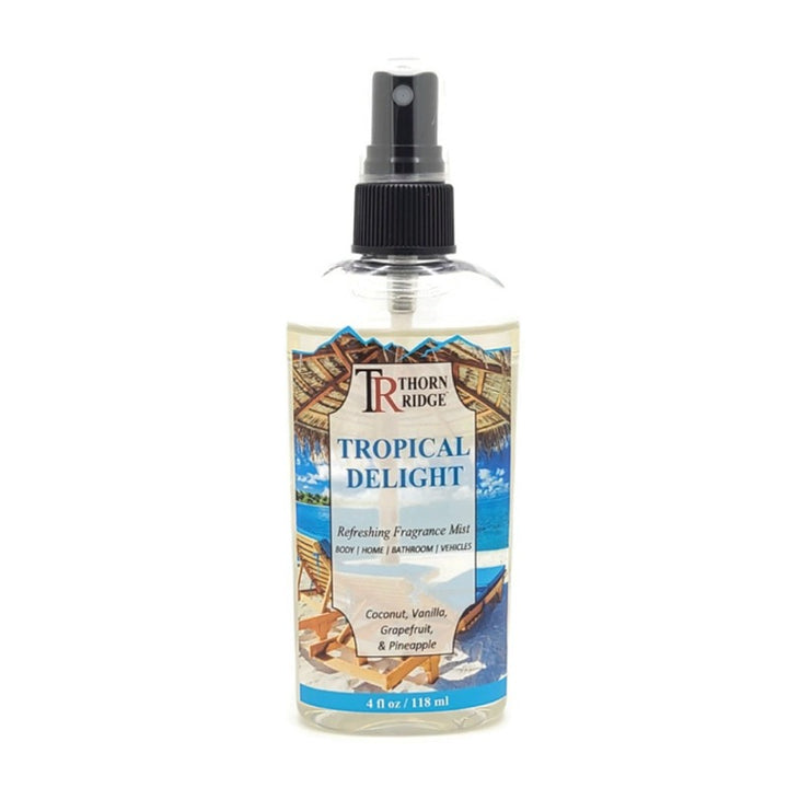 A bottle of Thorn Ridge fragrance mist labeled "Tropical Delight" described as a coconut, vanilla, grapefruit, and pineapple scent for body, home, bathroom, and vehicles. 4 fl oz.