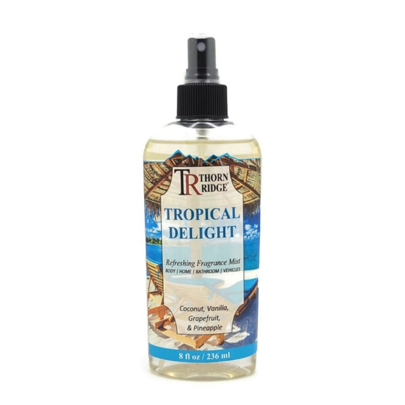 A bottle of Thorn Ridge fragrance mist labeled "Tropical Delight" described as a coconut, vanilla, grapefruit, and pineapple scent for body, home, bathroom, and vehicles. 8 fl oz.