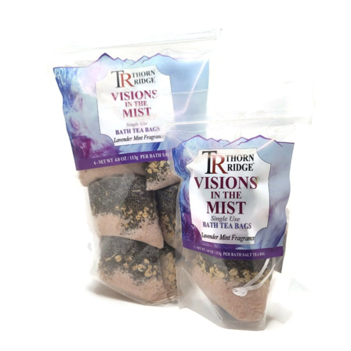 A bag of Thorn Ridge single use bath tea bag soaks labeled "Visions In The Mist," described as a lavender mint fragrance. 4.0 oz per bath tea. 6 pack. 24 oz total. 2 pack also pictured.