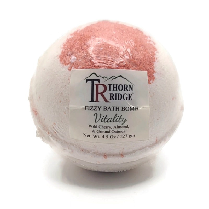 A Thorn Ridge fizzy bath bomb labeled "Vitality," described as a wild cherry, almond, and ground oatmeal  fragrance. 4.5 oz.