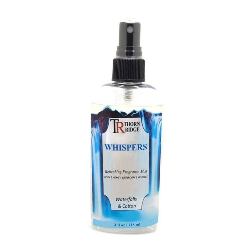 A bottle of Thorn Ridge fragrance mist labeled "Whispers," described as a waterfalls and cotton scent for body, home, bathroom, and vehicles. 4 fl oz.