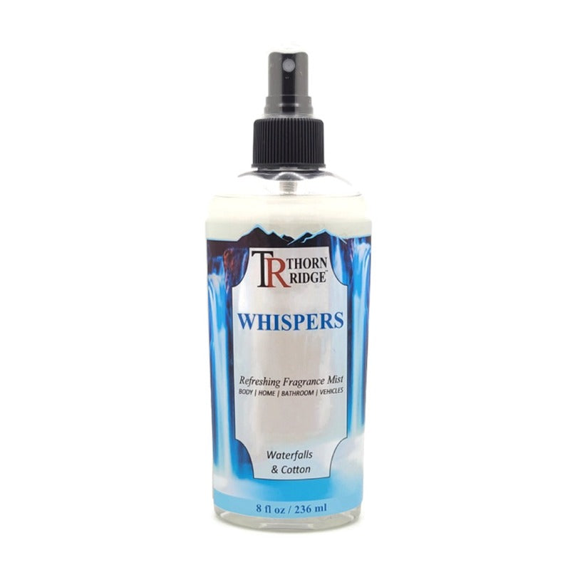 A bottle of Thorn Ridge fragrance mist labeled "Whispers," described as a waterfalls and cotton scent for body, home, bathroom, and vehicles. 8 fl oz.