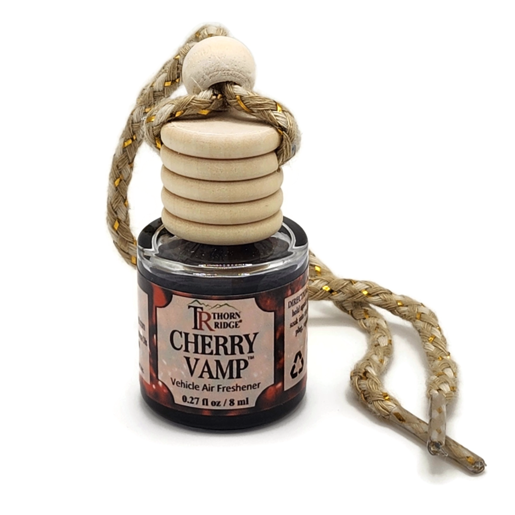 Thorn Ridge® CherryVamp Car Air Freshener Round bottle with wooden top and gold threaded cord.