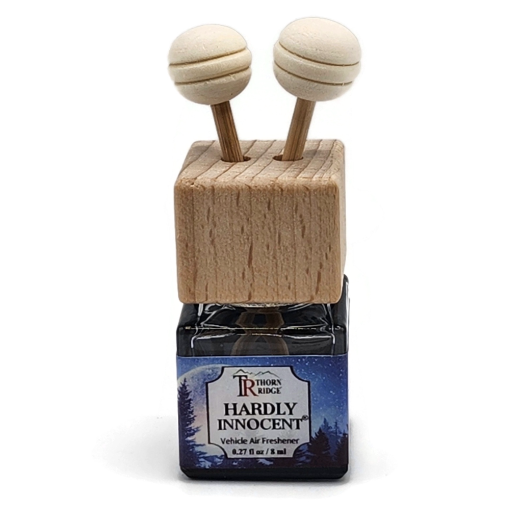 Thorn Ridge® Hardly Innocent® Car Air Freshener sqare bottle with wooden top and two wooden diffuser sticks with round wooden balls on top of each stick.
