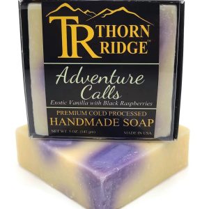 Packaging of Thorn Ridge soap labeled "Adventure Calls," described as exotic vanilla with black raspberries, premium cold processed, handmade, 5 oz. Made in USA.