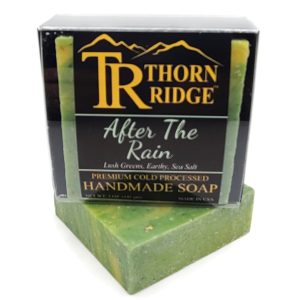 Packaging of Thorn Ridge soap labeled "After The Rain," described as lush greens, earthy, sea salt, premium cold processed, handmade, 5 oz. Made in USA.