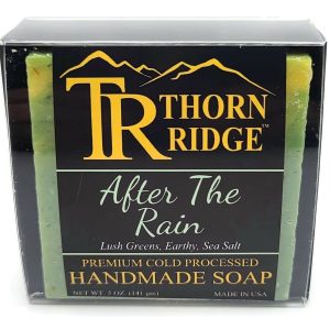 Packaging of Thorn Ridge soap labeled "After The Rain," described as lush greens, earthy, sea salt, premium cold processed, handmade, 5 oz. Made in USA.