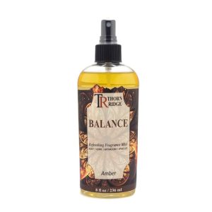 A bottle of Thorn Ridge fragrance mist labeled "Balance," described as an amber scent for body, home, bathroom, and vehicles. 8 fl oz.