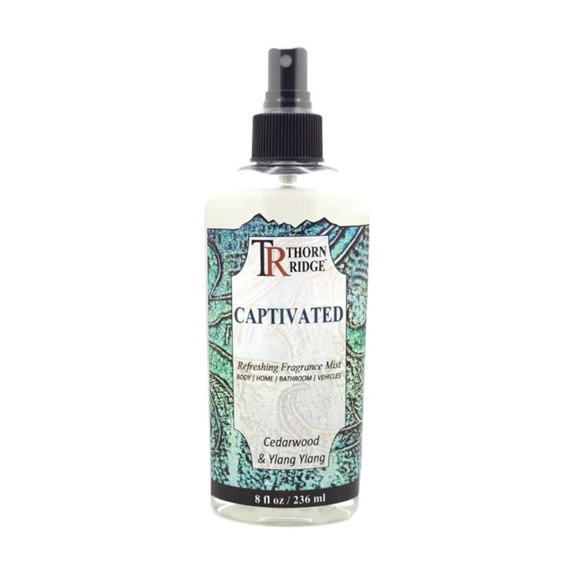 A bottle of Thorn Ridge fragrance mist labeled "Captivated," described as a cedarwood and ylang ylang scent for body, home, bathroom, and vehicles. 8 fl oz.
