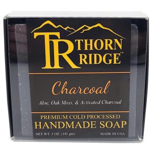 Packaging of Thorn Ridge soap labeled "Charcoal," described as aloe, oak moss, activated charcoal, premium cold processed, handmade, 5 oz. Made in USA.