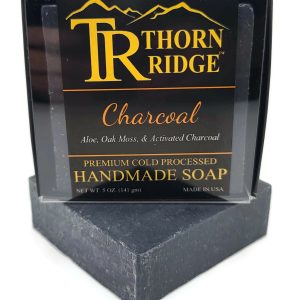 Packaging of Thorn Ridge soap labeled "Charcoal," described as aloe, oak moss, activated charcoal, premium cold processed, handmade, 5 oz. Made in USA.
