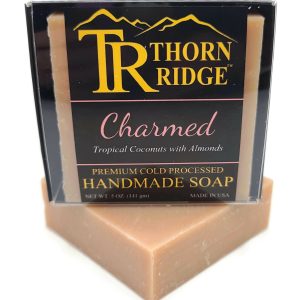 Packaging of Thorn Ridge soap labeled "Charmed," described as tropical coconuts with almonds, premium cold processed, handmade, 5 oz. Made in USA.
