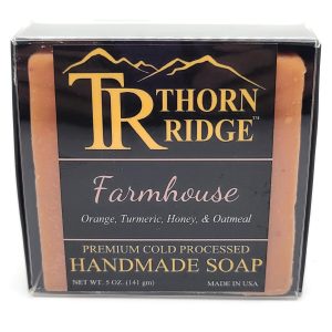 Packaging of Thorn Ridge soap labeled "Farmhouse," described as orange, turmeric, honey, oatmeal, premium cold processed, handmade, 5 oz. Made in USA.