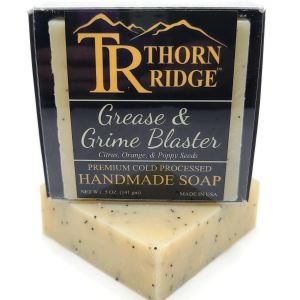 Packaging of Thorn Ridge soap labeled "Grease and Grime Blaster," described as citrus, orange, poppy seeds, premium cold processed, handmade, 5 oz. Made in USA.