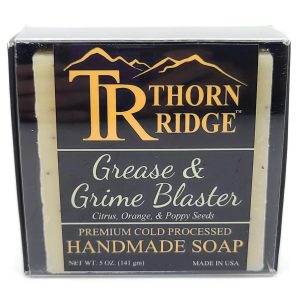 Packaging of Thorn Ridge soap labeled "Grease and Grime Blaster," described as citrus, orange, poppy seeds, premium cold processed, handmade, 5 oz. Made in USA.