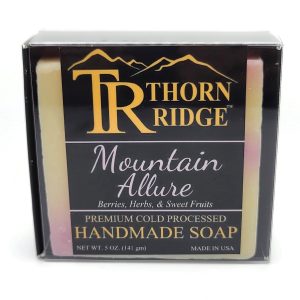 Packaging of Thorn Ridge soap labeled "Mountain Allure," described as berries, herbs, sweet fruits, premium cold processed, handmade, 5 oz. Made in USA.