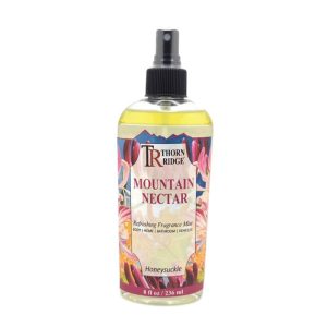 A bottle of Thorn Ridge fragrance mist labeled "Mountain Nectar," described as a honeysuckle scent for body, home, bathroom, and vehicles. 8 fl oz.