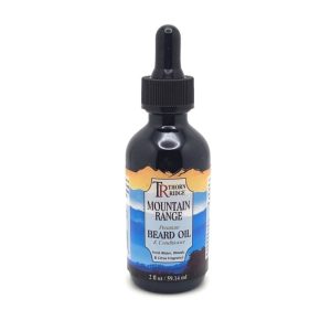 A bottle of Thorn Ridge beard oil labeled "Mountain Range," described as a premium beard oil and conditioner with a fresh water, woods, and citrus scent. 2 fl oz.