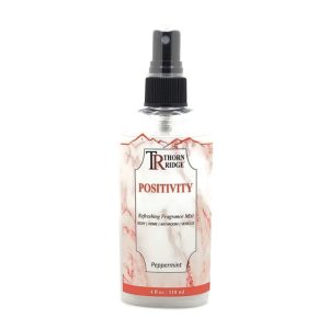 A bottle of Thorn Ridge fragrance mist labeled "Positivity," described as a peppermint scent for body, home, bathroom, and vehicles. 4 fl oz.