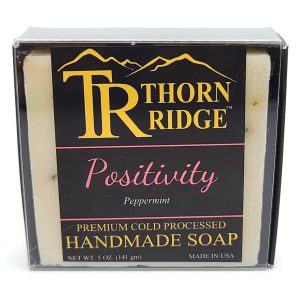 Packaging of Thorn Ridge soap labeled "Positivity," described as peppermint, premium cold processed, handmade, 5 oz. Made in USA.