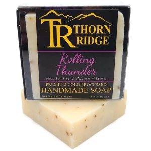 Packaging of Thorn Ridge soap labeled "Rolling Thunder," described as mint, tea tree, and peppermint leaves, premium cold processed, handmade, 5 oz. Made in USA.