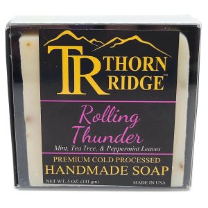 Packaging of Thorn Ridge soap labeled "Rolling Thunder," described as mint, tea tree, and peppermint leaves, premium cold processed, handmade, 5 oz. Made in USA.